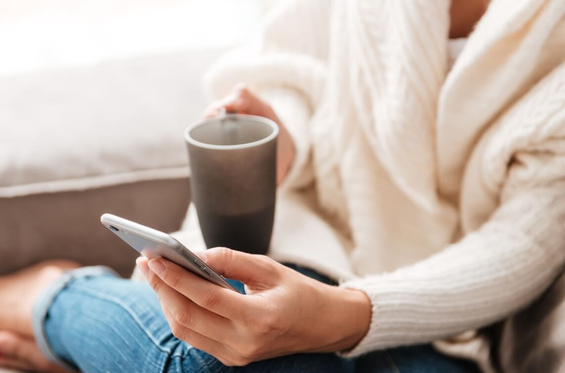 Woman reading blog on her phone